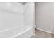 Bright white tile tub and shower at 5252 Sunstone Mesa Dr, Las Vegas, NV 89166