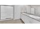 Bright bathroom boasts double sinks and a glass-enclosed shower for a spa-like feel at 5252 Sunstone Mesa Dr, Las Vegas, NV 89166