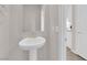 Powder room with pedestal sink and mirror at 5252 Sunstone Mesa Dr, Las Vegas, NV 89166