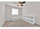 Bright bedroom with a ceiling fan, neutral carpet, and built-in white shelving for storage at 5252 Sunstone Mesa Dr, Las Vegas, NV 89166