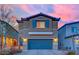 Charming two-story home with a two-car garage and a well-maintained paver driveway at dusk at 5252 Sunstone Mesa Dr, Las Vegas, NV 89166