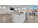 Open-concept kitchen with granite island, stainless steel dishwasher, and access to backyard patio at 5252 Sunstone Mesa Dr, Las Vegas, NV 89166