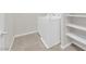 Practical laundry area with washer, dryer, and shelving for efficient organization at 5252 Sunstone Mesa Dr, Las Vegas, NV 89166