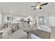 Bright, open-concept living room with tile floors, modern furniture, and recessed lighting at 5252 Sunstone Mesa Dr, Las Vegas, NV 89166
