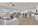Bright, open-concept living room with tile floors, modern furniture, and stainless steel appliances at 5252 Sunstone Mesa Dr, Las Vegas, NV 89166