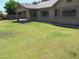 Expansive backyard featuring a covered patio and lush green lawn, perfect for outdoor entertaining and relaxation at 5488 Apron Ct, Las Vegas, NV 89122