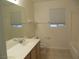 Well-lit bathroom with a single sink vanity, a window, and a shower-tub combo at 5488 Apron Ct, Las Vegas, NV 89122