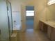 Primary bath with tiled floors, dual sinks, and separate shower & tub at 5488 Apron Ct, Las Vegas, NV 89122