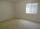 Comfortable bedroom featuring carpet flooring and a window for natural light at 5488 Apron Ct, Las Vegas, NV 89122