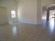 Bright living room with tiled flooring, a window for natural light, and an open layout at 5488 Apron Ct, Las Vegas, NV 89122