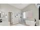 Bright bathroom with a glass enclosed shower and soaker tub in a modern style at 5600 Blue Peak Ave, Las Vegas, NV 89131