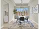 Elegant dining room featuring a modern chandelier, large windows, and stylish décor at 5600 Blue Peak Ave, Las Vegas, NV 89131