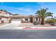 Charming single-story home with desert landscaping, a palm tree, and attached two-car garage at 5600 Blue Peak Ave, Las Vegas, NV 89131