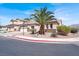 Charming single-story home with desert landscaping, a palm tree, and attached two-car garage at 5600 Blue Peak Ave, Las Vegas, NV 89131