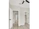 Hallway with multiple doors including to a bedroom, storage room, and other rooms at 5600 Blue Peak Ave, Las Vegas, NV 89131