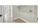 A bright, empty laundry room with clean lines and a doorway to a hallway at 5600 Blue Peak Ave, Las Vegas, NV 89131