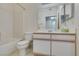 Bathroom featuring white cabinets and tile shower at 5751 E Hacienda Ave # 105, Las Vegas, NV 89122