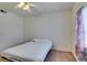 Cozy bedroom features a ceiling fan and natural light from the window at 5751 E Hacienda Ave # 105, Las Vegas, NV 89122
