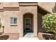 A front door with arched entryway complimented by desert landscaping at 5751 E Hacienda Ave # 105, Las Vegas, NV 89122