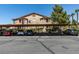 Community parking lot with assigned covered spaces and manicured landscaping at 5751 E Hacienda Ave # 105, Las Vegas, NV 89122