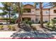 Attractive condo building exterior featuring well-maintained landscaping and convenient access to units at 5751 E Hacienda Ave # 105, Las Vegas, NV 89122