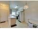 Kitchen area with white appliances and cabinets next to the front door and dining area at 5751 E Hacienda Ave # 105, Las Vegas, NV 89122