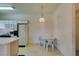 Bright kitchen features white cabinets, appliances and a casual dining area with a round table at 5751 E Hacienda Ave # 105, Las Vegas, NV 89122