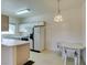 Kitchen and dining area with white cabinets, appliances, and dining table at 5751 E Hacienda Ave # 105, Las Vegas, NV 89122