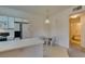 Well-lit kitchen featuring modern appliances and an open layout with dining area and bathroom entrance at 5751 E Hacienda Ave # 105, Las Vegas, NV 89122