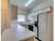 Kitchen featuring white cabinets, laminate countertops, and modern appliances at 5751 E Hacienda Ave # 105, Las Vegas, NV 89122