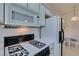 Kitchen featuring white appliances and cabinets and a view of dining area at 5751 E Hacienda Ave # 105, Las Vegas, NV 89122
