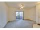 Bright living room with sliding glass doors leading to a patio and a view of the surrounding landscape at 5751 E Hacienda Ave # 105, Las Vegas, NV 89122