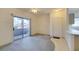 Living room featuring sliding glass doors to a balcony, plus access to front door and kitchen area at 5751 E Hacienda Ave # 105, Las Vegas, NV 89122