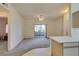 Spacious living room with carpet flooring and sliding glass doors to a balcony at 5751 E Hacienda Ave # 105, Las Vegas, NV 89122