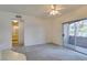 An airy living room featuring neutral carpet, ceiling fan, and patio access at 5751 E Hacienda Ave # 105, Las Vegas, NV 89122