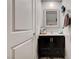 Stylish powder room with a dark vanity and decorative mirror at 6231 Portland Treaty Ave, Las Vegas, NV 89122