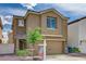 Two-story home featuring a two-car garage, neutral stucco, and a well-maintained front yard at 6231 Portland Treaty Ave, Las Vegas, NV 89122