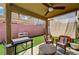 Covered patio with wicker furniture offers a cozy outdoor living space at 6231 Portland Treaty Ave, Las Vegas, NV 89122