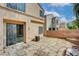 Backyard showcasing a stone patio, brick wall, and access to the home with a sliding glass door at 6549 Butterfly Sky St, North Las Vegas, NV 89084