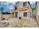 Backyard with a stone patio, brick wall, and views of the home's exterior and surrounding landscape at 6549 Butterfly Sky St, North Las Vegas, NV 89084