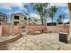 Backyard featuring a stone patio area with a brick wall and landscaping at 6549 Butterfly Sky St, North Las Vegas, NV 89084