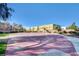 Outdoor basketball court surrounded by trees and landscaping in community area with nearby homes at 6549 Butterfly Sky St, North Las Vegas, NV 89084