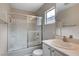 Bathroom features a shower-tub combo and a modern single sink vanity with light-colored cabinets at 6549 Butterfly Sky St, North Las Vegas, NV 89084