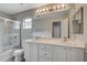 Bright bathroom features a double sink vanity with a large mirror and a shower-tub combo at 6549 Butterfly Sky St, North Las Vegas, NV 89084