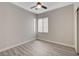 Bedroom with wood-style floors, a ceiling fan, and a window bringing in natural light at 6549 Butterfly Sky St, North Las Vegas, NV 89084