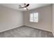 This bedroom features a ceiling fan and a window that offers ample natural light at 6549 Butterfly Sky St, North Las Vegas, NV 89084