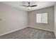 This bedroom features a ceiling fan and a window that offers ample natural light at 6549 Butterfly Sky St, North Las Vegas, NV 89084
