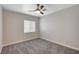 This bedroom features a ceiling fan and a window that offers ample natural light at 6549 Butterfly Sky St, North Las Vegas, NV 89084