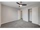 This bedroom features a ceiling fan, closet and light-colored walls at 6549 Butterfly Sky St, North Las Vegas, NV 89084