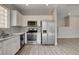Spacious kitchen featuring stainless steel appliances, marble countertops, and modern lighting at 6549 Butterfly Sky St, North Las Vegas, NV 89084
